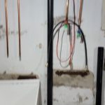 Basement sink drain being installed