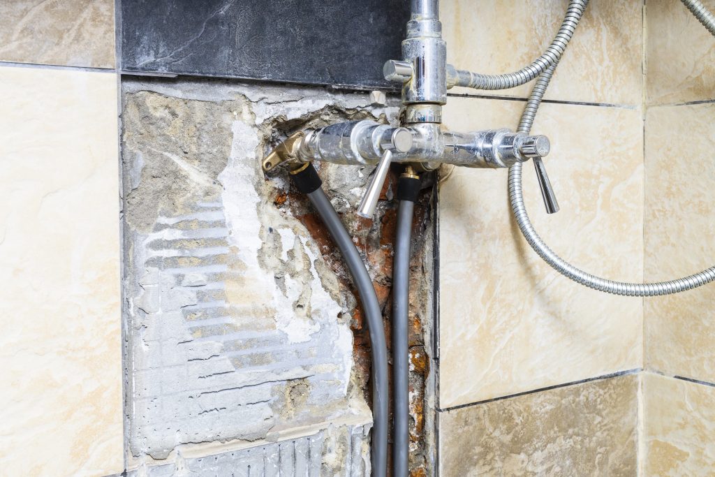 water pipes connected to faucet inside broken wall 2022 03 30 19 18 18 utc